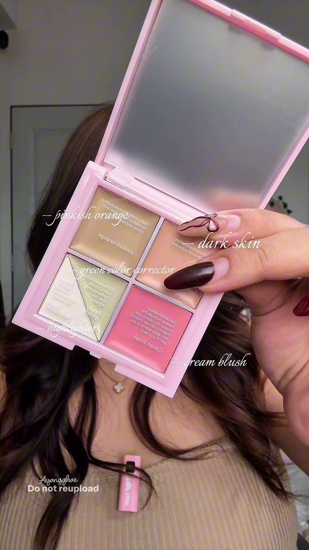 A compact palette taken apart on camera — shades shown, swatched on the arm, then worn.